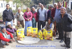 A group of physically challenged Indian Leprosy patients with dry food rations in large bags 